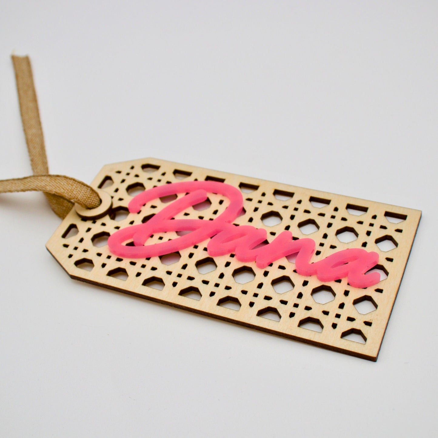 Close up of rattan tag with pink text