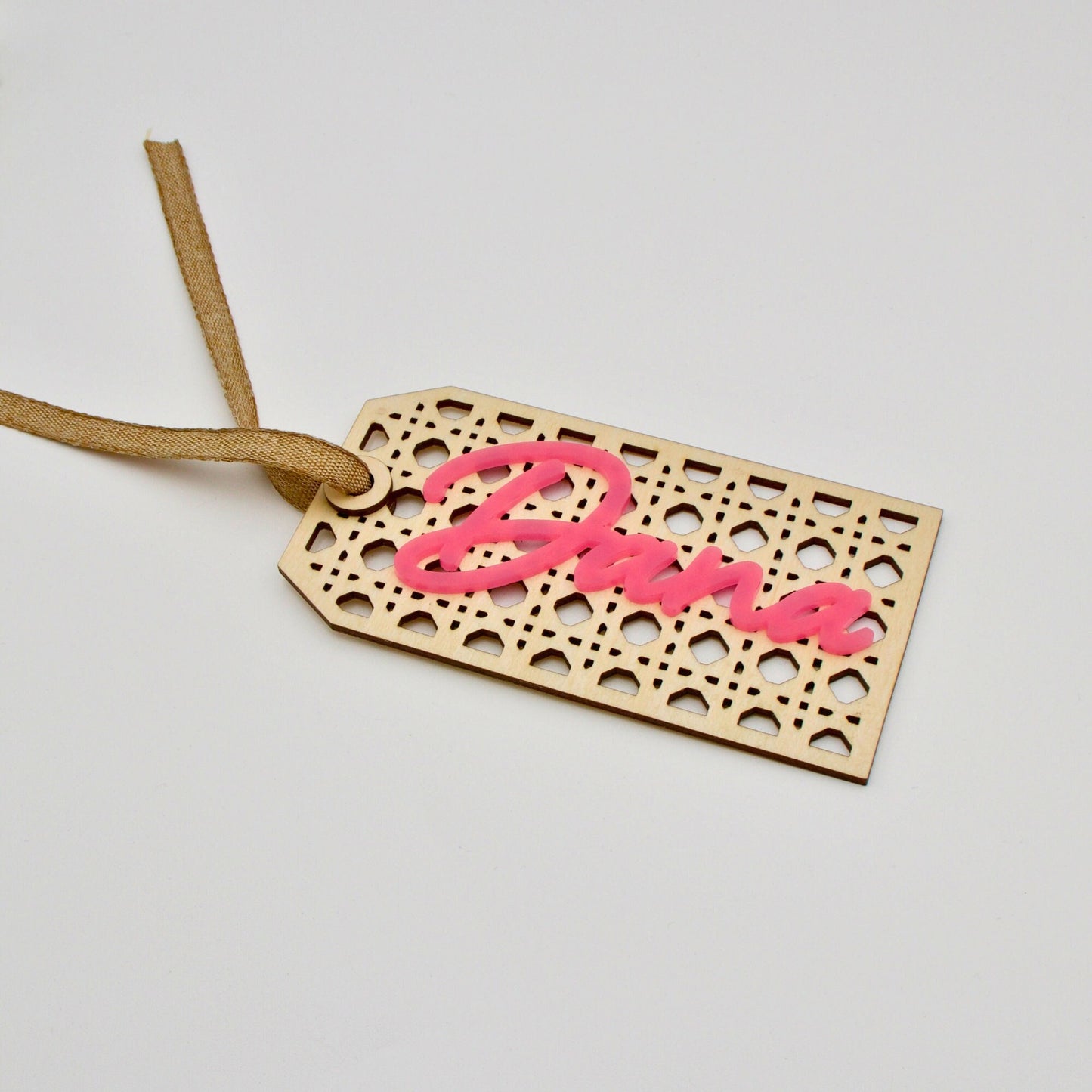 Side angle of rattan tag with pink text