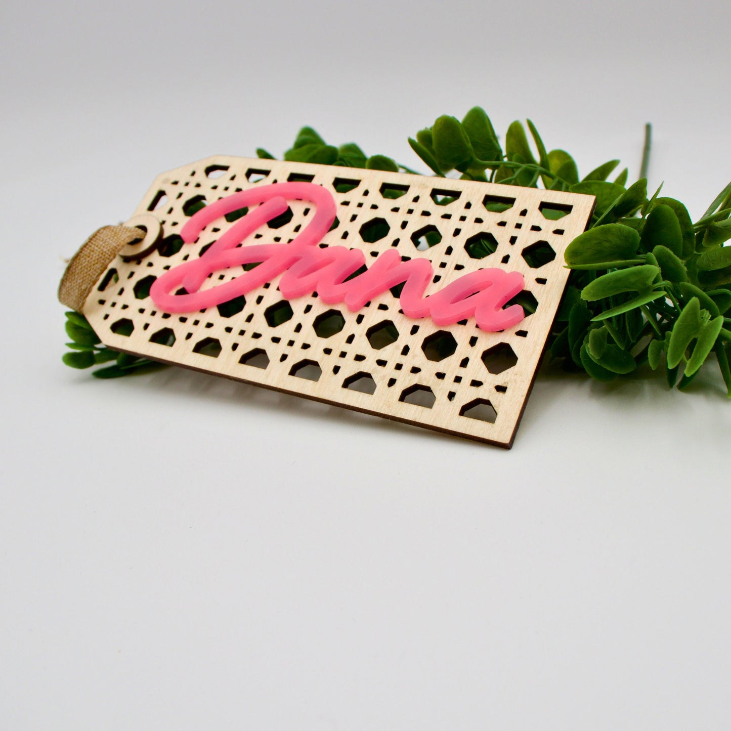 Rattan tag resting on leaves