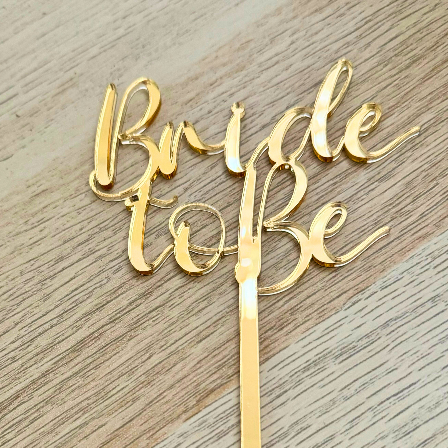 Gold bride to be cake topper close up