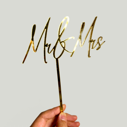 Gold MR&MRS cake topper on white background