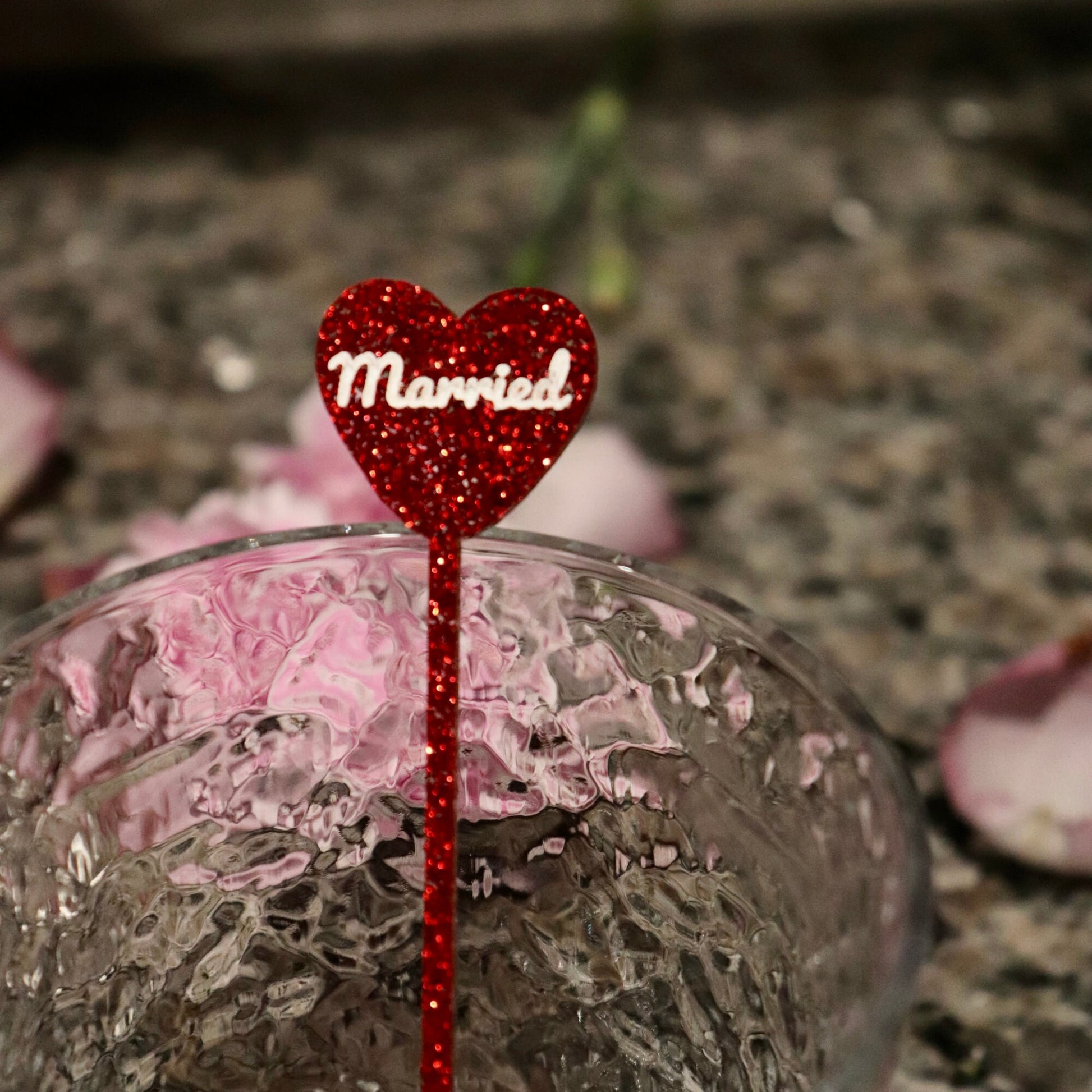 Red glitter acrylic stirrer with “married” engraved