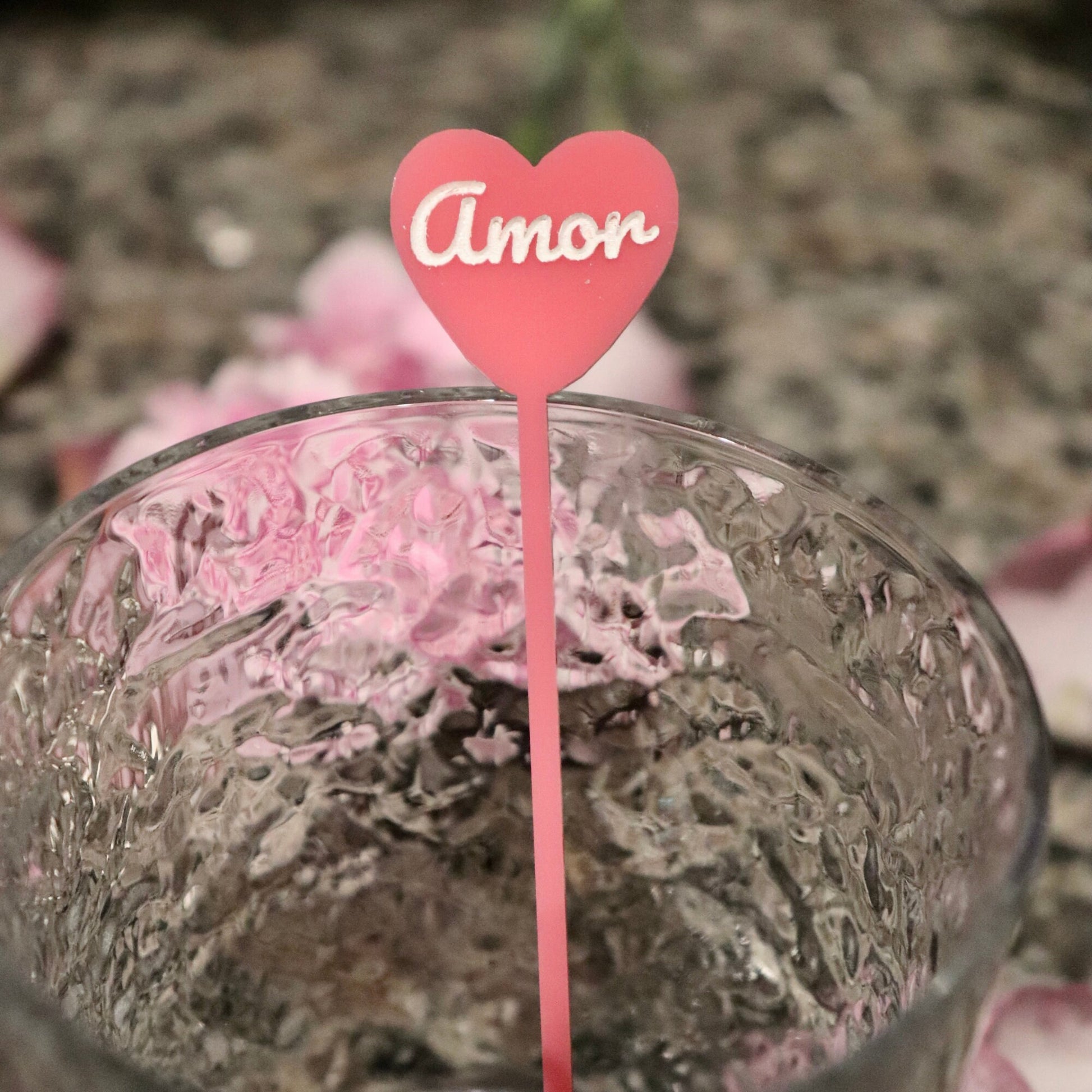 Pink acrylic stirrer with “amor” engraved