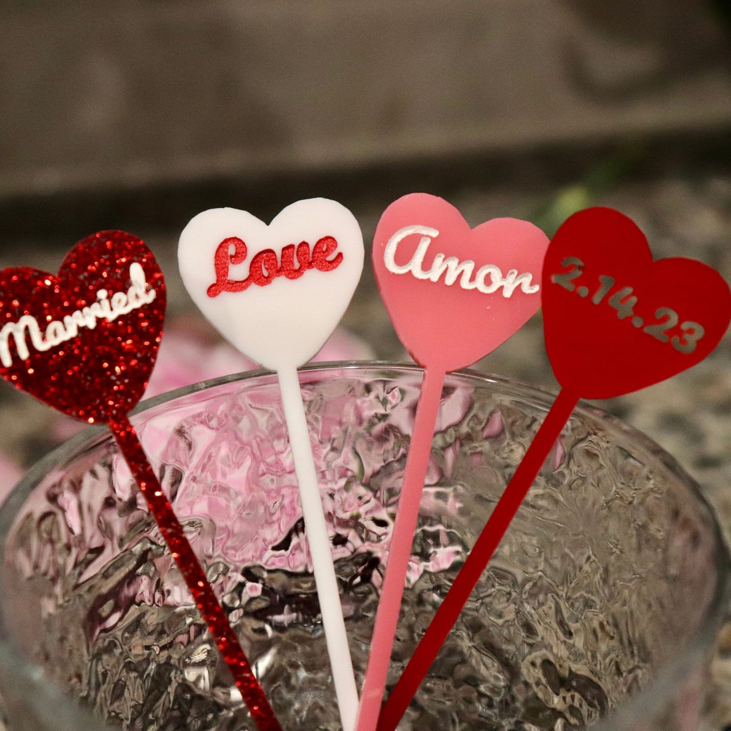 4 drink stirrers all in different acrylic colors and engravings to demonstrate variety of options