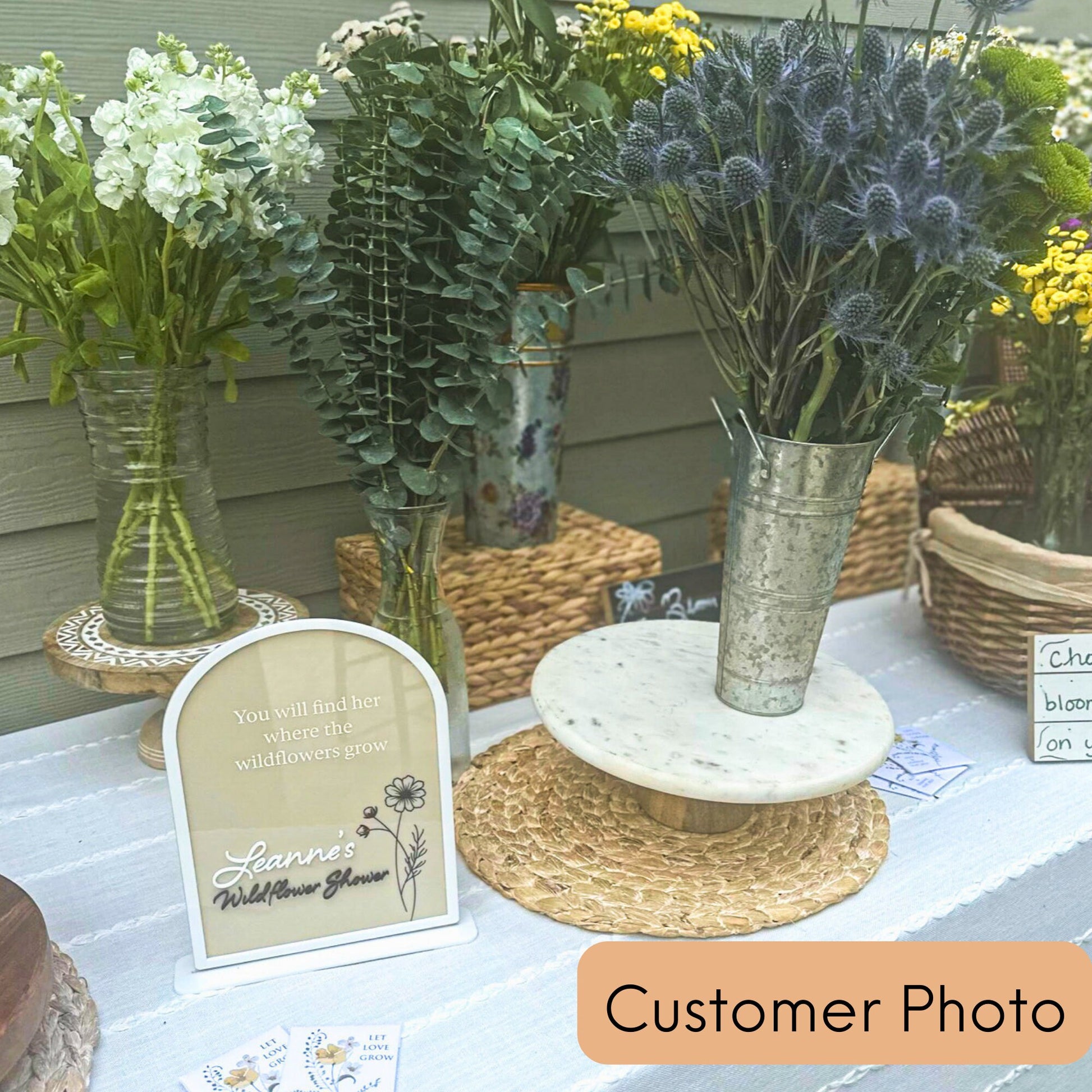 Customer photo of the arches sign on a table surrounded by wildflowers