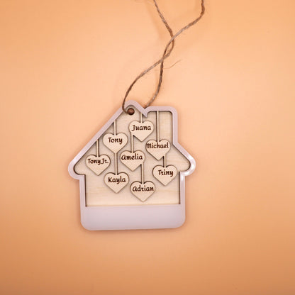 Lying down image of the White acrylic house ornament with 8 custom names on wooden hearts