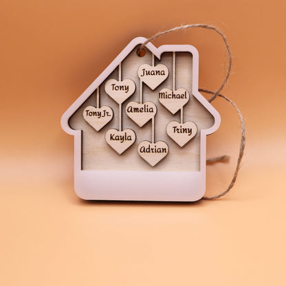 White acrylic house ornament with 8 custom names on wooden hearts