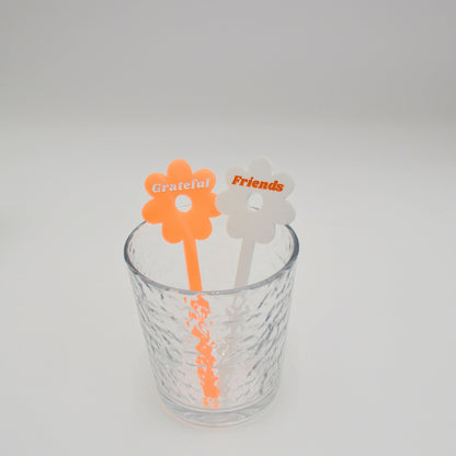 Neon orange and white drink stirs in a cup