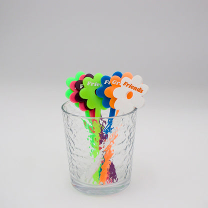 Assortment of neon drink stirrers in a cup